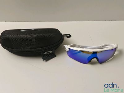 sunglasses and case on a white table with a black bag