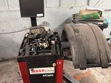 a tire being worked on by a mechanic in a garage