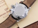 a watch sitting on top of a book on a table
