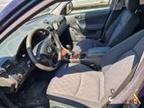 the interior of a purple car with a steering wheel and dashboard