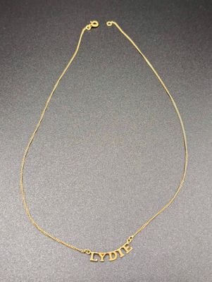 a gold plated necklace with the word love written on it