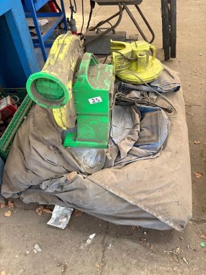 a pile of garbage on the ground next to a blue cart