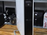 a black and white air purifier sitting on a wooden counter