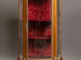 an antique display cabinet with glass doors and gold trimmings