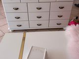 a white dresser with a mirror on top of it
