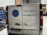 a van that is parked in a warehouse with boxes on the back of it
