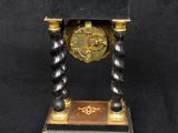 a black and gold clock sitting on a black table