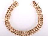 a gold chain bracelet with a clasp on a white background