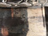 a close up of a silver vase on a table