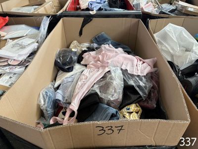de nombreux cartons de vêtements et d'autres objets dans une pièce