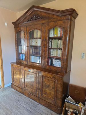 a large wooden bookcase with many books on it