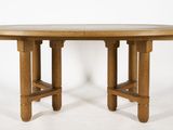 a wooden table with two legs and a round table top