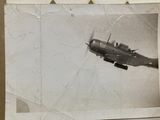 an old photo of a small plane flying in the sky