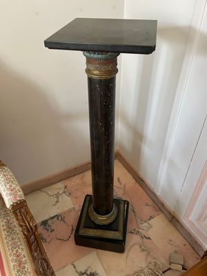 a small table with a black top sitting on the floor