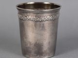 an antique silver cup with a decorative design on the rim