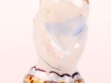 a white and blue vase sitting on top of a table