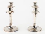 pair of silver plated candlesticks on a white background