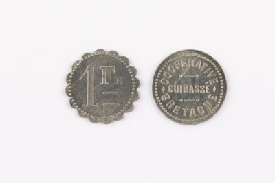 an old coin with the number one on it next to an old one