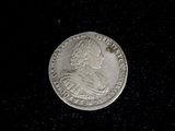 a silver coin with a picture of a man on it