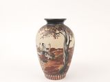 a vase with a painting on it sitting on a white surface