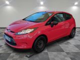 a red ford fiesta parked in a room with a checkered floor
