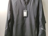 a close up of a jacket hanging on a hanger on a wall