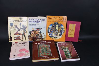 several books are lined up on a black surface