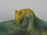 a figurine of a man on a wave in the water