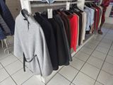 a lot of clothes hanging on a rack in a store