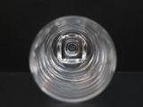 a clear glass with a small hole in the middle of it