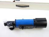 a blue and black telescope on a white surface