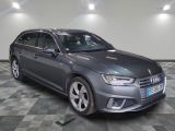 the grey audi is parked in a room with a checkered floor