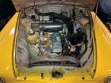 a small engine in the back of a yellow car