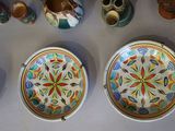 many bowls and vases that are on the table