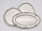 three silver trays on a white background