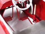 a close up of a red car with a steering wheel