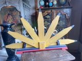 a wooden sunburst on a table in a room