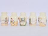 four vases with pictures of people on them are lined up in a row