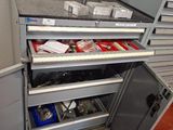 a metal workbench with a drawer full of tools