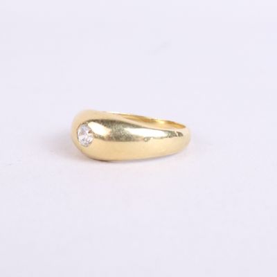 a gold ring with a single diamond in the middle