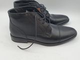 a pair of black leather boots with laces on them