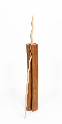 a tall wooden candle with a crack in the middle