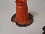 two orange vases sitting on a white table