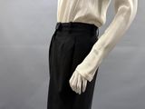 an image of a mannequin wearing a white shirt and black pants