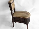 a wooden chair with a striped seat and back
