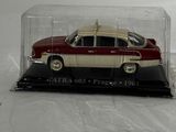 a red and white car in a glass case