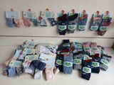 many pairs of socks hanging on the wall next to each other