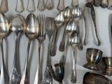 many spoons and spoon spoons hanging on a wall