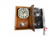 a clock that is hanging on the wall next to a key