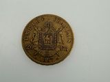 a gold coin with a coat of arms and a crown on it